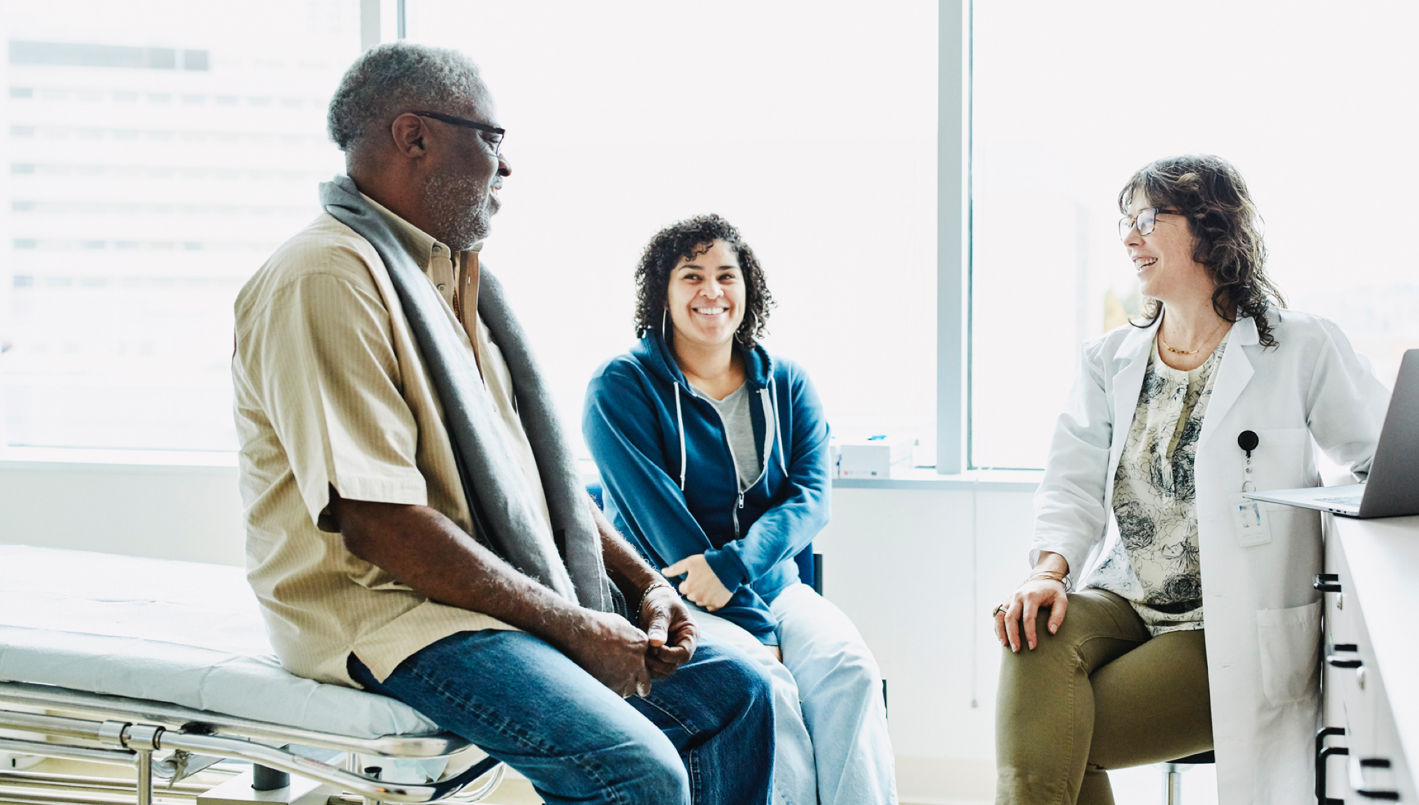 Older man and daughter talking to happy doctor | BCBS of Tennessee
