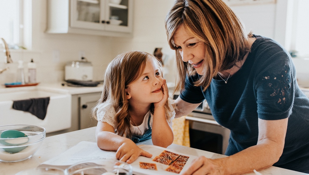 grandmother and toddler reading recipe