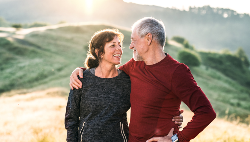 Older couple embracing and smiling at each other while hiking in the mountains | BCBS of Tennessee
Older couple embracing and smiling at each other while hiking in the mountains | BCBS of Tennessee