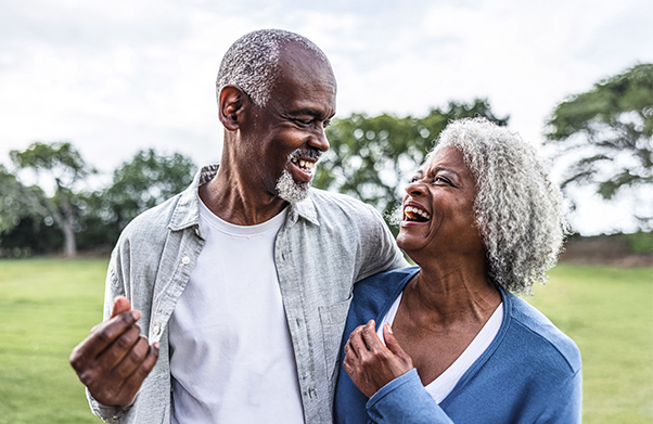 Husband and wife hugging and laughing.
