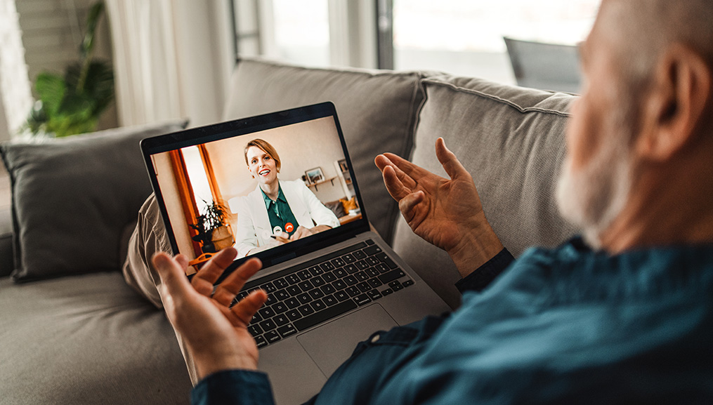 A senior man on a telehealth call with his doctor.