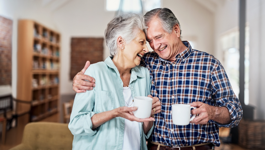 Senior woman and man laughing and drinking coffee | BCBS of Tennessee