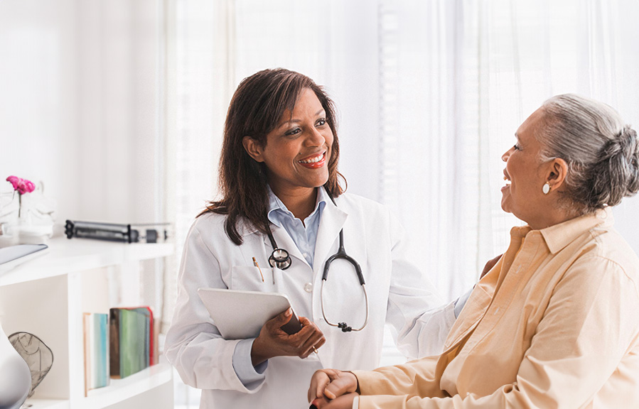 A doctor encourages her senior patient.