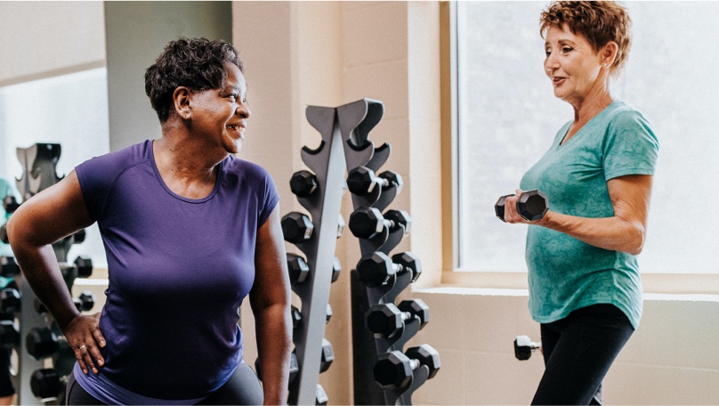 Two older women working out in a gym