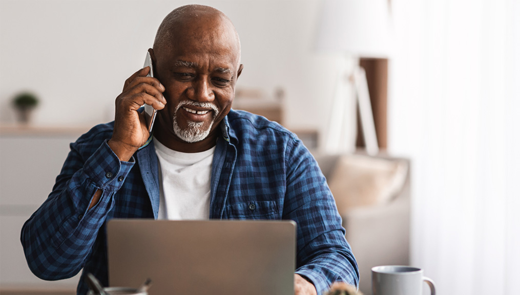 An older man enrolling in the BlueAdvantage Freedom plan over the phone.