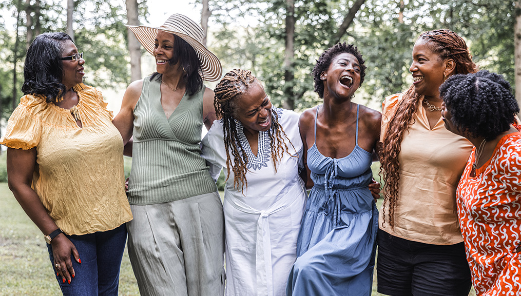 Group of women laughing in the park.
