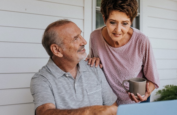 Older couple looking at information on their laptop