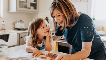grandmother and toddler reading recipe
