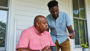 Father and son examining a prescription bottle Father and son examining a prescription bottle