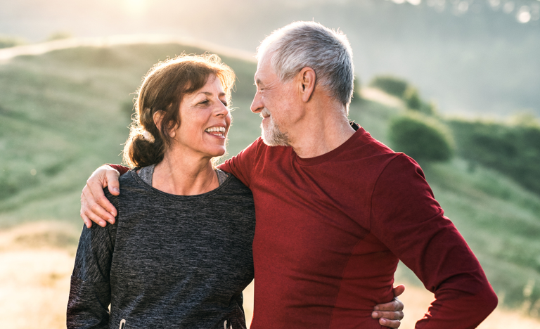 Older couple embracing and smiling at each other while hiking in the mountains | BCBS of Tennessee
Older couple embracing and smiling at each other while hiking in the mountains | BCBS of Tennessee