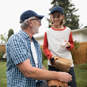 Senior man playing baseball with a child | BCBS of Tennessee