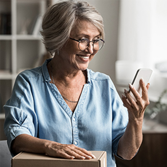 Woman checking her online OTC order on her phone.
