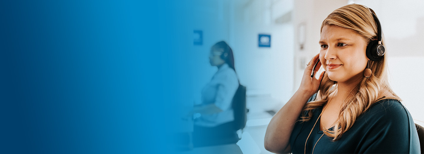 A female BlueCross BlueShield of Tennessee team member helping someone enroll in a plan over the phone.